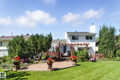 Back of house with a chimney, a pergola, and a patio - 39 Grand Meadow Crescent, Edmonton, AB - Outdoor