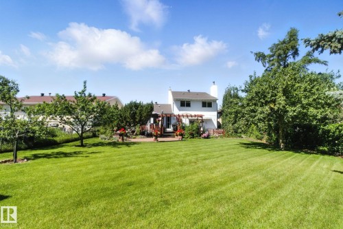 View of grassy yard featuring a patio area and a pergola - 39 Grand Meadow Crescent, Edmonton, AB - Outdoor