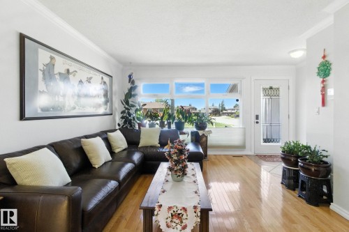 Living area featuring light wood finished floors and crown molding - 39 Grand Meadow Crescent, Edmonton, AB - Indoor Photo Showing Living Room
