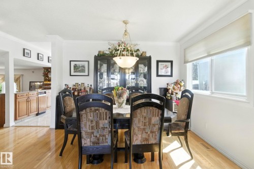 Dining room with light wood-type flooring and crown molding - 39 Grand Meadow Crescent, Edmonton, AB - Indoor Photo Showing Dining Room