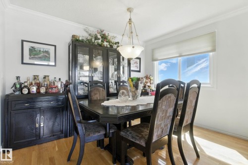 Dining area with light wood-style floors and ornamental molding - 39 Grand Meadow Crescent, Edmonton, AB - Indoor Photo Showing Dining Room