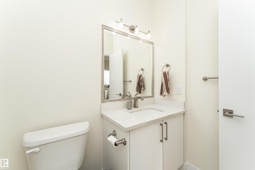 Half bathroom featuring toilet and vanity - 2 11569 University Avenue, Edmonton, AB - Indoor Photo Showing Bathroom