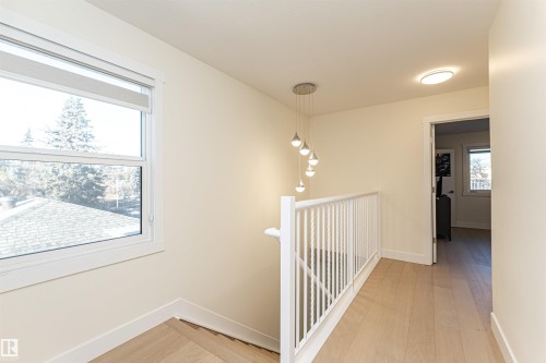 Hall with light wood finished floors and an upstairs landing - 2 11569 University Avenue, Edmonton, AB - Indoor Photo Showing Other Room