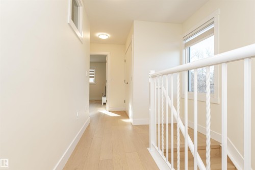 Corridor with light wood-style flooring and baseboards - 2 11569 University Avenue, Edmonton, AB - Indoor Photo Showing Other Room