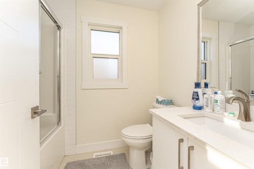Bathroom featuring vanity and combined bath / shower with glass door - 2 11569 University Avenue, Edmonton, AB - Indoor Photo Showing Bathroom