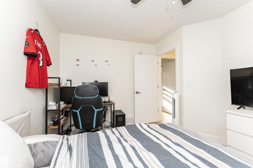 Bedroom featuring a ceiling fan and a desk - 2 11569 University Avenue, Edmonton, AB - Indoor Photo Showing Bedroom