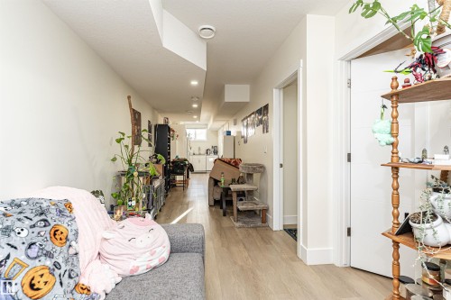 Hall with light wood-style floors and baseboards - 2 11569 University Avenue, Edmonton, AB - Indoor Photo Showing Other Room