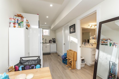 Kitchen with light wood-style flooring, white appliances, recessed lighting, and light countertops - 2 11569 University Avenue, Edmonton, AB - Indoor Photo Showing Other Room