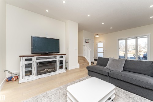 Living area featuring light wood-style floors and recessed lighting - 2 11569 University Avenue, Edmonton, AB - Indoor Photo Showing Living Room