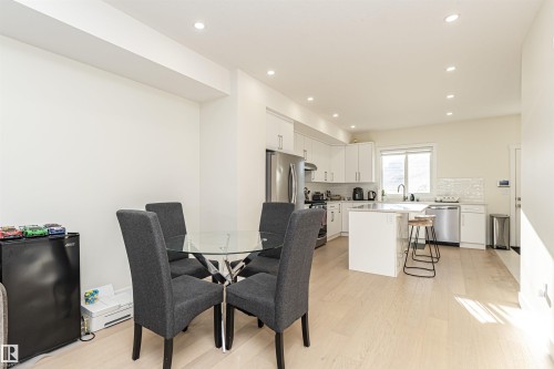 Dining room with light wood-style floors and recessed lighting - 2 11569 University Avenue, Edmonton, AB - Indoor