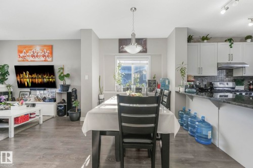 Dining space with dark wood-style floors and rail lighting - 2428 Wonnacott Crest, Edmonton, AB - Indoor