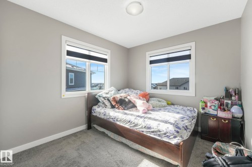 Bedroom with baseboards and light carpet - 2428 Wonnacott Crest, Edmonton, AB - Indoor Photo Showing Bedroom