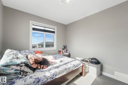Bedroom featuring baseboards and carpet floors - 2428 Wonnacott Crest, Edmonton, AB - Indoor Photo Showing Bedroom