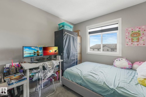 Bedroom with light carpet and a desk - 2428 Wonnacott Crest, Edmonton, AB - Indoor Photo Showing Bedroom