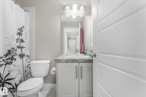 Full bathroom featuring vanity and curtained shower - 2428 Wonnacott Crest, Edmonton, AB - Indoor Photo Showing Bathroom