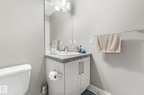 Half bathroom featuring vanity and toilet - 2428 Wonnacott Crest, Edmonton, AB - Indoor Photo Showing Bathroom