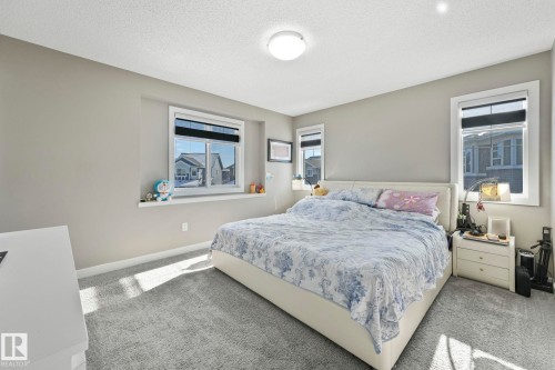 Bedroom featuring carpet and a textured ceiling - 2428 Wonnacott Crest, Edmonton, AB - Indoor Photo Showing Bedroom