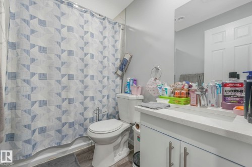 Bathroom with vanity and shower / bath combination with curtain - 2428 Wonnacott Crest, Edmonton, AB - Indoor Photo Showing Bathroom