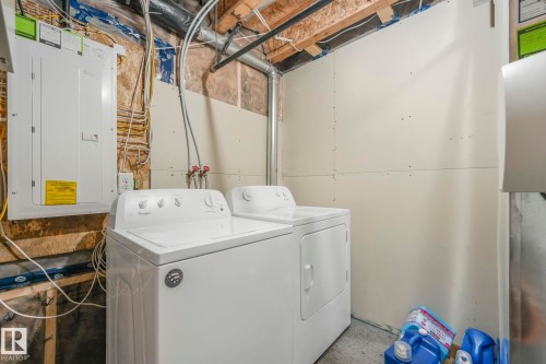 Laundry area featuring electric panel and separate washer and dryer - 2428 Wonnacott Crest, Edmonton, AB - Indoor Photo Showing Laundry Room