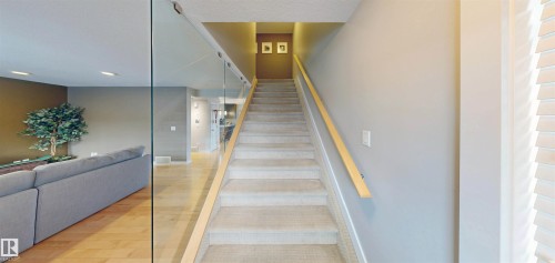Stairway featuring wood finished floors and recessed lighting - 8 9535 217 Street, Edmonton, AB - Indoor Photo Showing Other Room