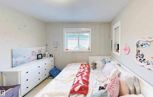 Bedroom featuring a textured ceiling - 8 9535 217 Street, Edmonton, AB - Indoor Photo Showing Bedroom