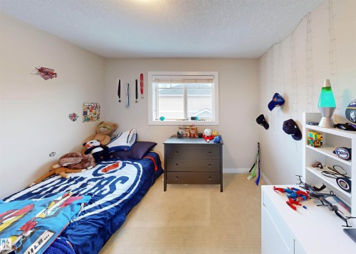 Bedroom with light carpet and a textured ceiling - 8 9535 217 Street, Edmonton, AB - Indoor Photo Showing Bedroom