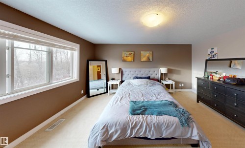 Bedroom with light carpet and a textured ceiling - 8 9535 217 Street, Edmonton, AB - Indoor Photo Showing Bedroom