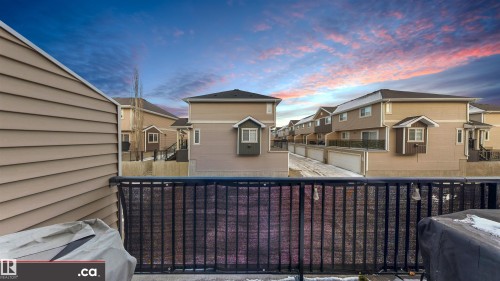 Back of property with a residential view and a balcony - 8 9535 217 Street, Edmonton, AB - Outdoor With Exterior