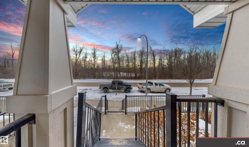 Patio terrace at dusk featuring covered porch - 8 9535 217 Street, Edmonton, AB - Outdoor With Exterior