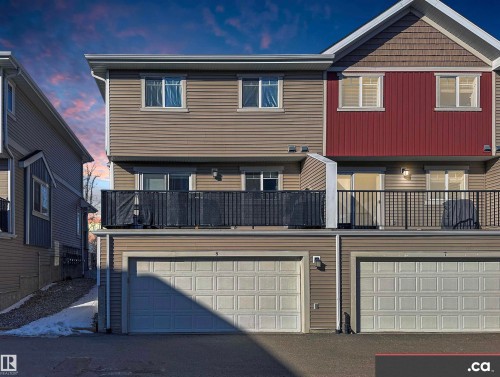 View of front of house featuring a balcony, an attached garage, and asphalt driveway - 8 9535 217 Street, Edmonton, AB - Outdoor With Balcony