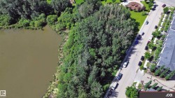 Waterfront property featuring a wooded shoreline and direct water access - 