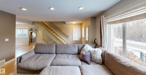 Living area with wood finished floors and recessed lighting - 8 9535 217 Street, Edmonton, AB - Indoor Photo Showing Living Room