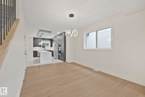 Unfurnished living room featuring light wood-type flooring, a chandelier, and recessed lighting - 10965 129 Street, Edmonton, AB - Indoor Photo Showing Other Room