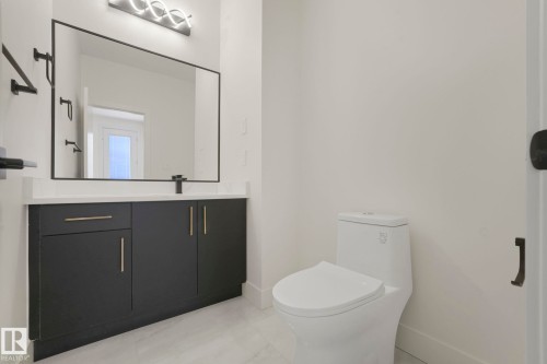 Bathroom with vanity and light tile patterned floors - 10965 129 Street, Edmonton, AB - Indoor Photo Showing Bathroom