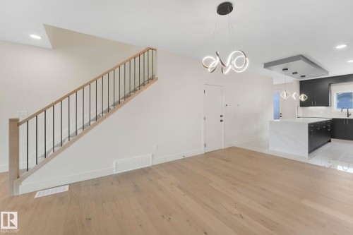 Stairway and a chandelier - 10965 129 Street, Edmonton, AB - Indoor Photo Showing Other Room