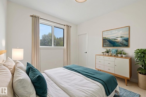 Bedroom with light carpet and baseboards - 10965 129 Street, Edmonton, AB - Indoor Photo Showing Bedroom