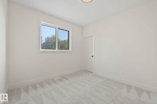 Carpeted bedroom with baseboards - 10965 129 Street, Edmonton, AB - Indoor Photo Showing Other Room