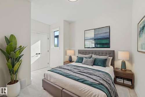 Bedroom with carpet flooring and baseboards - 10965 129 Street, Edmonton, AB - Indoor Photo Showing Bedroom