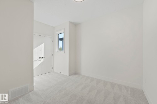 Bedroom featuring light carpet and baseboards - 10965 129 Street, Edmonton, AB - Indoor Photo Showing Other Room