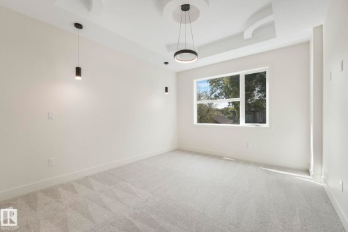 Unfurnished primary bedroom with a raised ceiling and carpet flooring - 10965 129 Street, Edmonton, AB - Indoor Photo Showing Other Room
