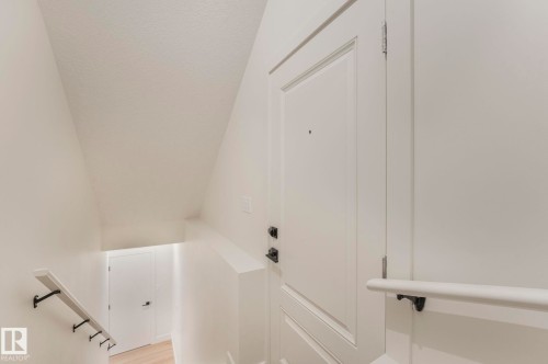 Separate Entrance & Staircase to Basement with wood finished floors - 10965 129 Street, Edmonton, AB - Indoor Photo Showing Other Room