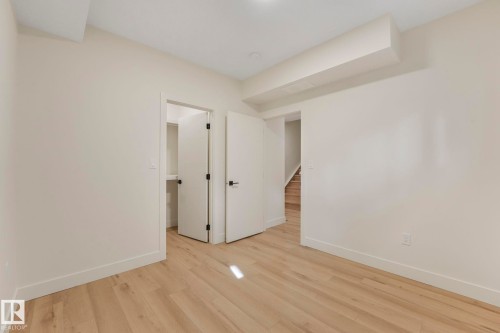Bedroom with baseboards and wood finished floors - 10965 129 Street, Edmonton, AB - Indoor Photo Showing Other Room