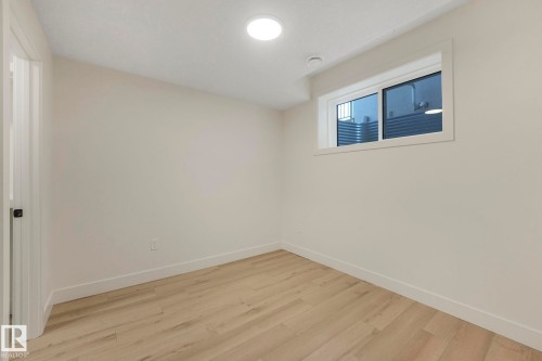 Bedroom featuring light wood finished floors and baseboards - 10965 129 Street, Edmonton, AB - Indoor Photo Showing Other Room