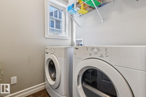 Laundry room featuring dark wood-type flooring and washer and dryer - 5409 3 Avenue, Edmonton, AB - Indoor Photo Showing Laundry Room