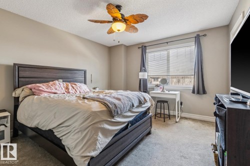 Bedroom featuring carpet floors, a ceiling fan, and a textured ceiling - 5409 3 Avenue, Edmonton, AB - Indoor Photo Showing Bedroom