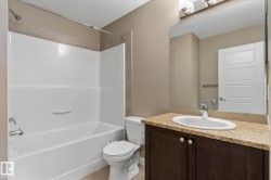 Bathroom with a textured ceiling, vanity, and bathtub / shower combination - 