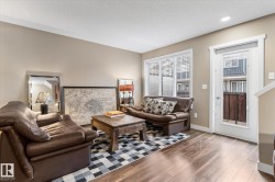 Living area featuring wood finished floors and a textured ceiling - 