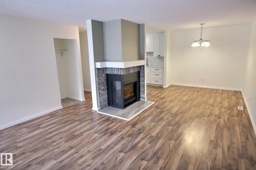 11 1503 Mill Woods Road E, Edmonton, AB - Indoor Photo Showing Living Room With Fireplace