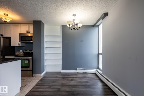 good sized dining area and has large window with view of west city view and U of A campus - 911 10883 Saskatchewan Drive, Edmonton, AB - Indoor Photo Showing Kitchen
