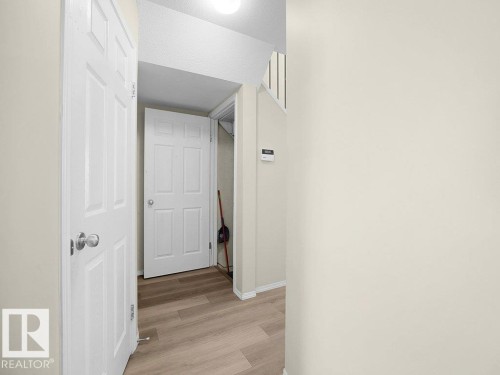 Hallway with light wood finished floors and baseboards - 196 230 Edwards Drive, Edmonton, AB - Indoor